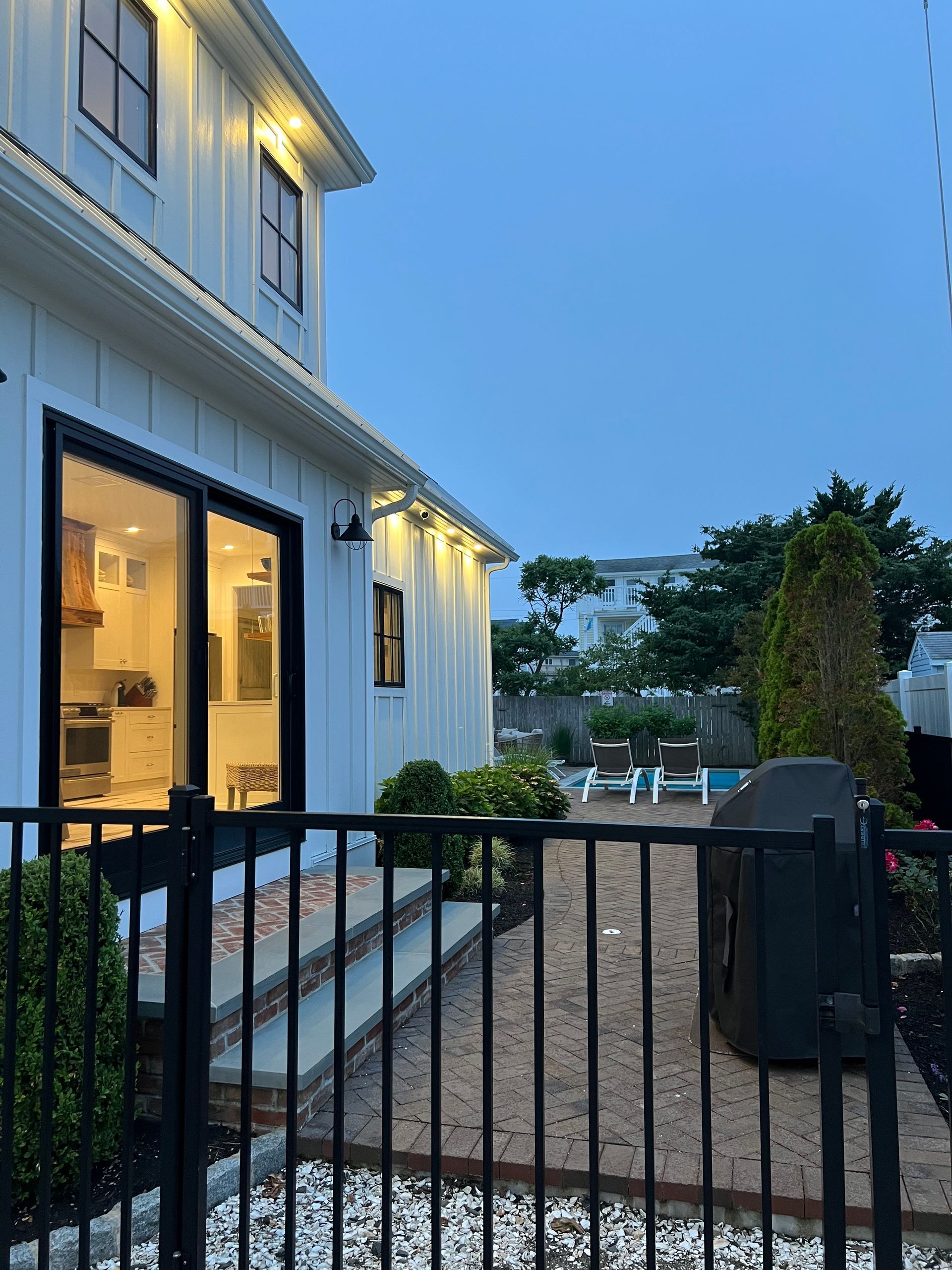 A white house with a black fence in front of it