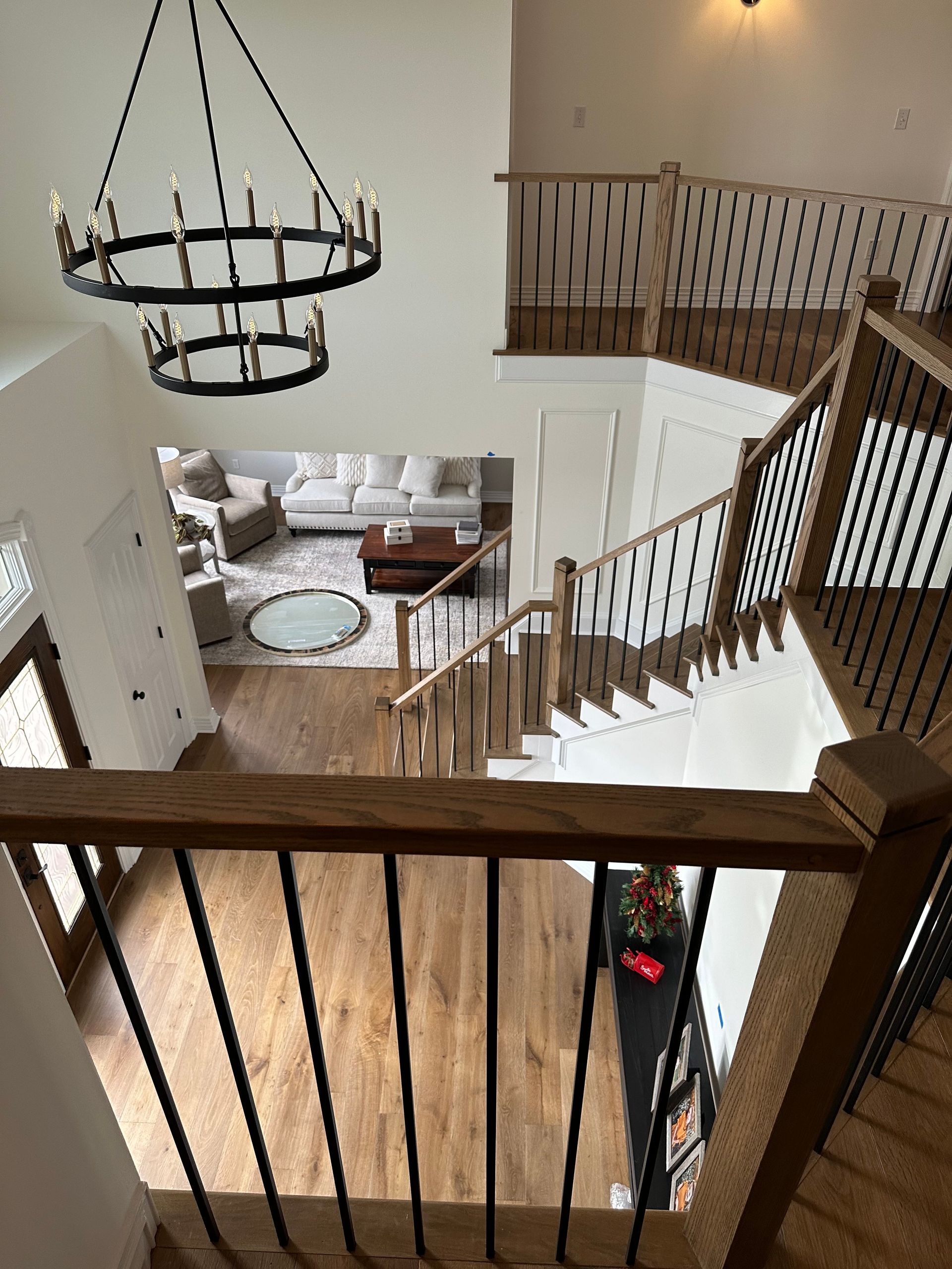 A view of a living room from the second floor of a house.