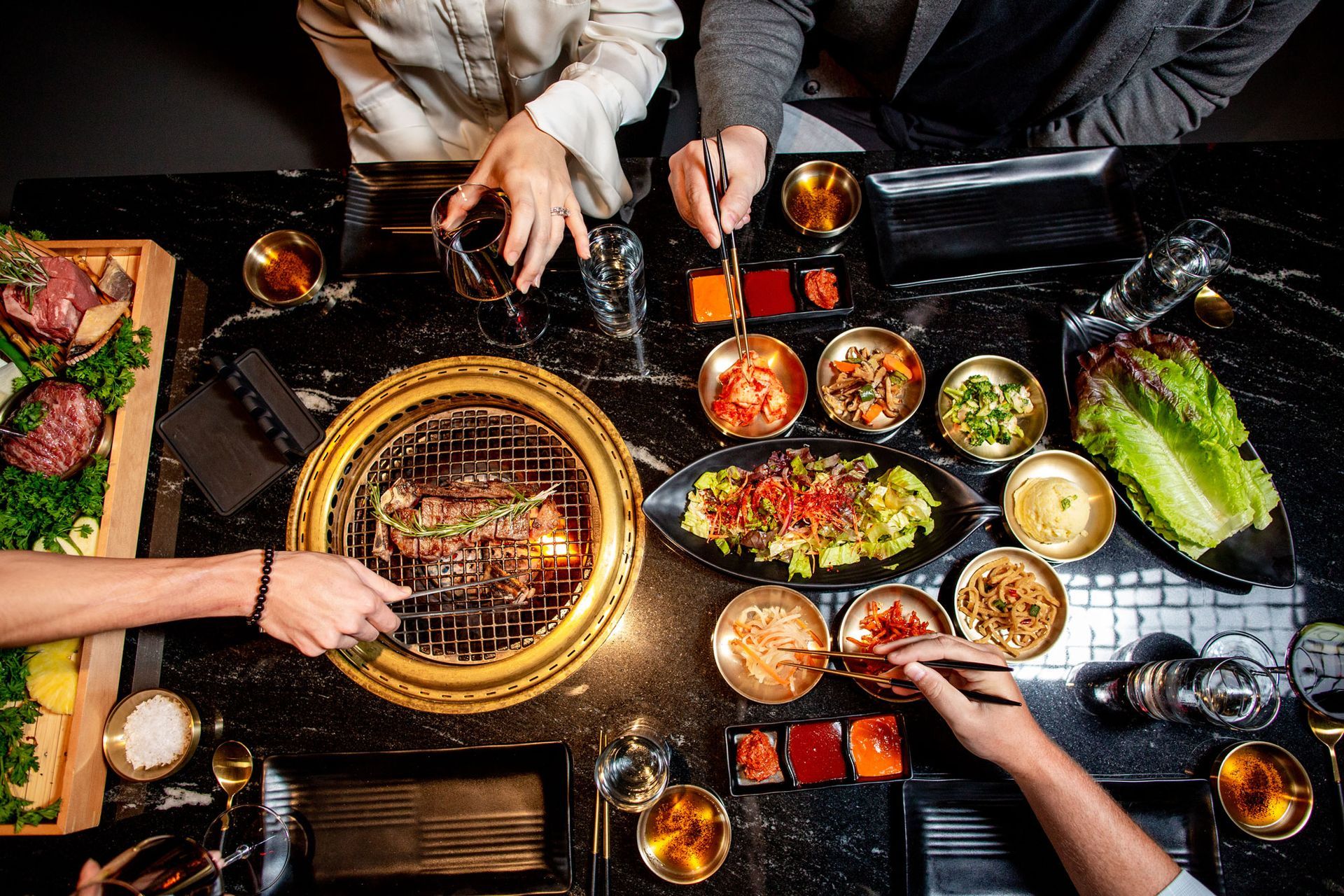 A group of people are sitting at a table eating food.