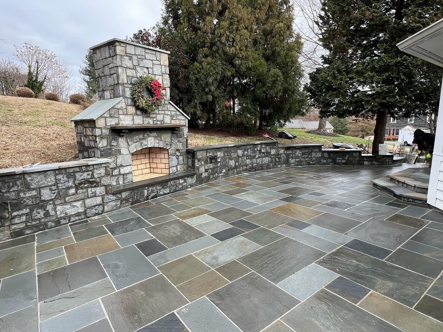 there is a fireplace in the middle of the patio .