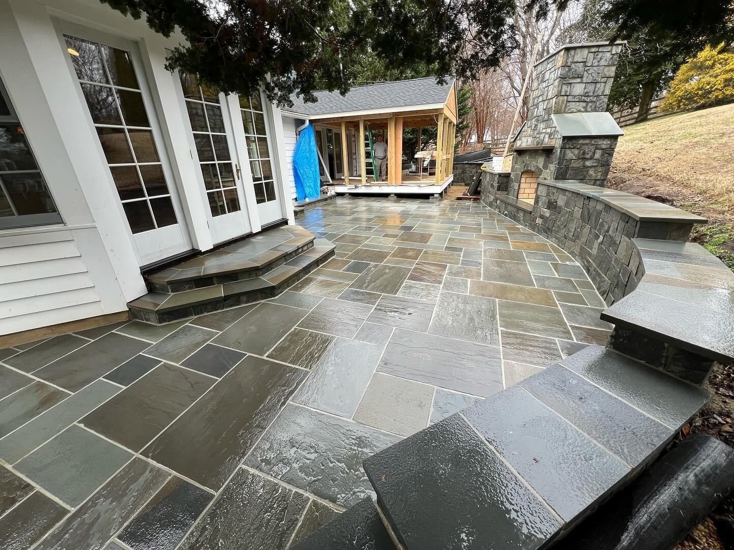 a patio with steps leading to a house in the background .