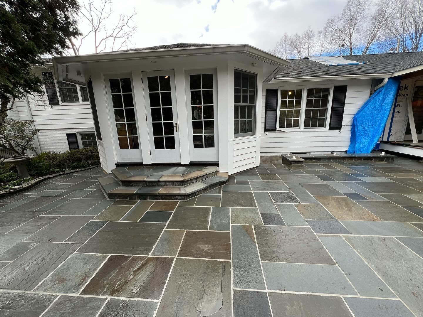 a white house with a stone patio