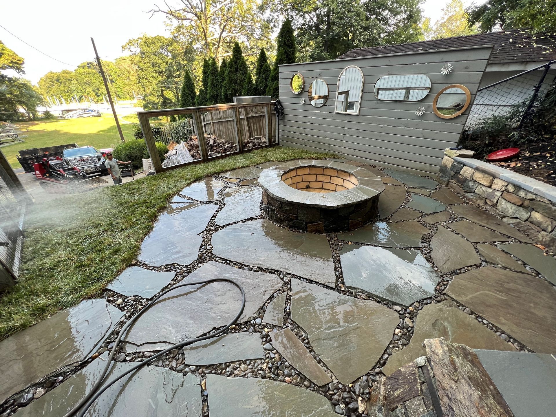a fire pit is sitting in the middle of a stone patio .