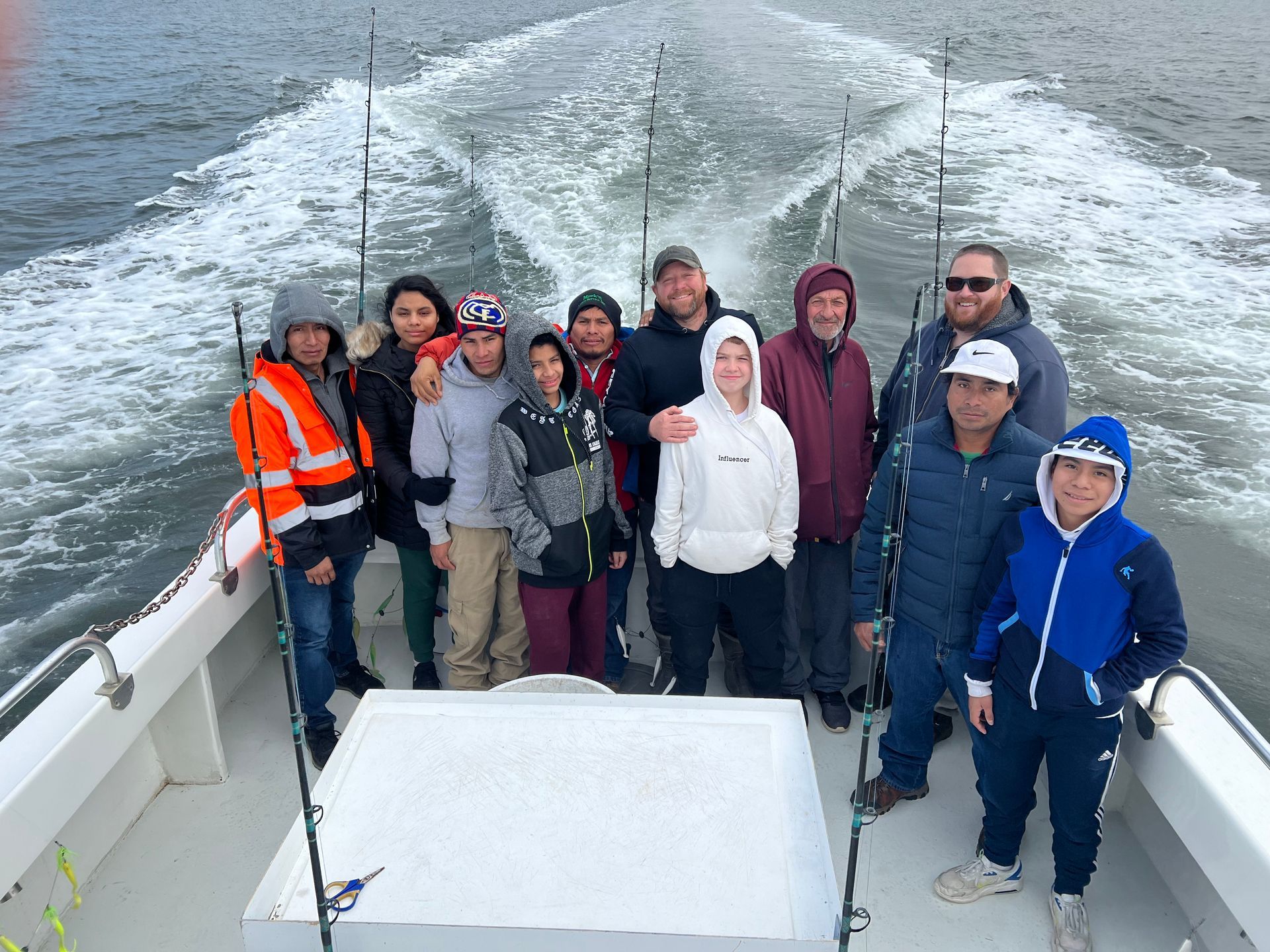 a group of people are posing for a picture on a boat .