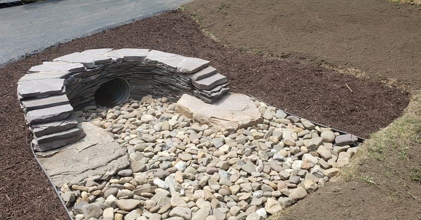 There is a hole in the ground that looks like a tunnel