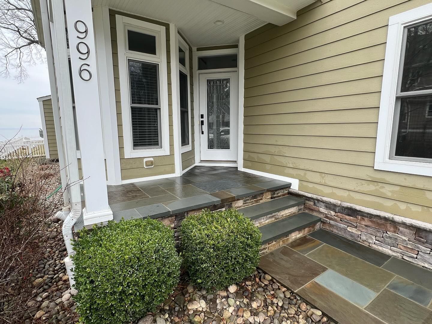 A house with a porch and steps leading to the front door
