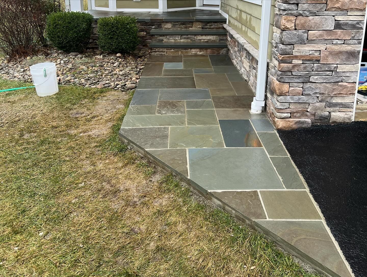 A stone walkway leading to the front door of a house