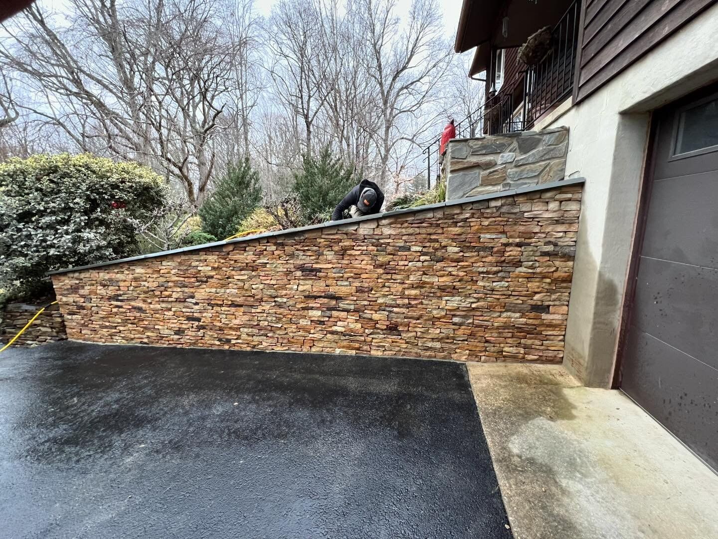 There is a brick wall between the garage and the house