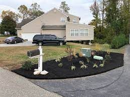 a house with a mailbox and a car parked in front of it .