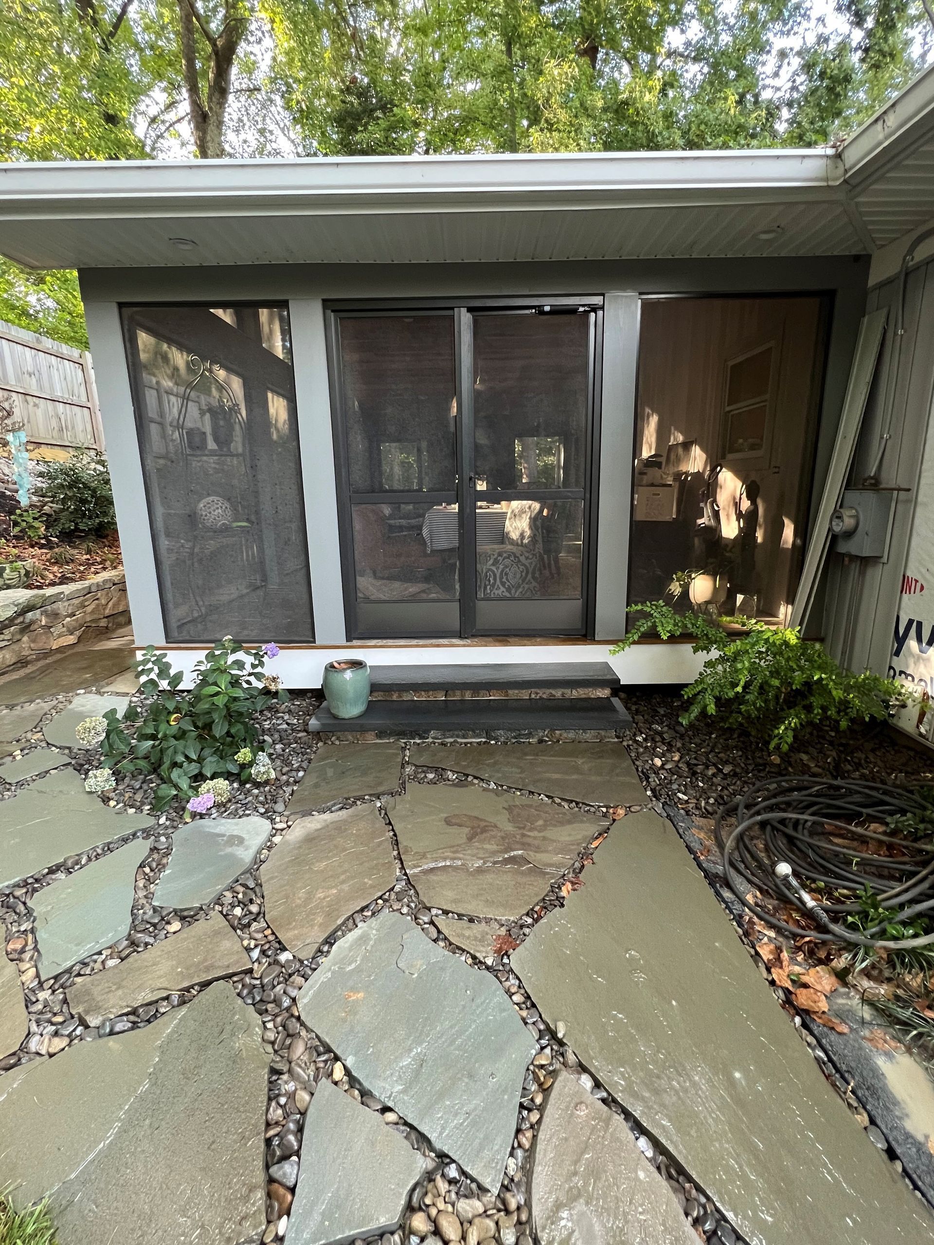 a small house with a stone walkway leading to it
