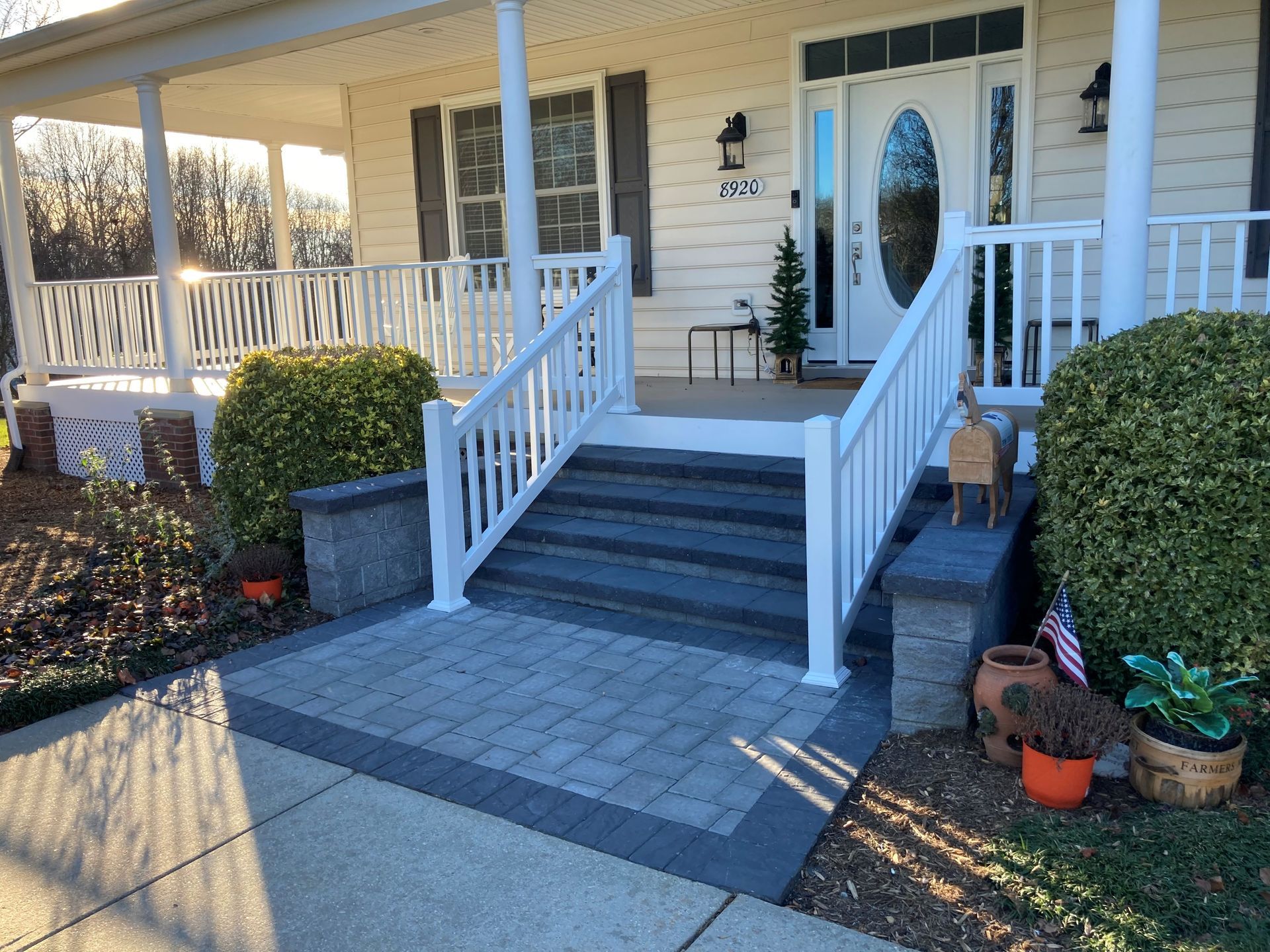 a white house with a porch and stairs