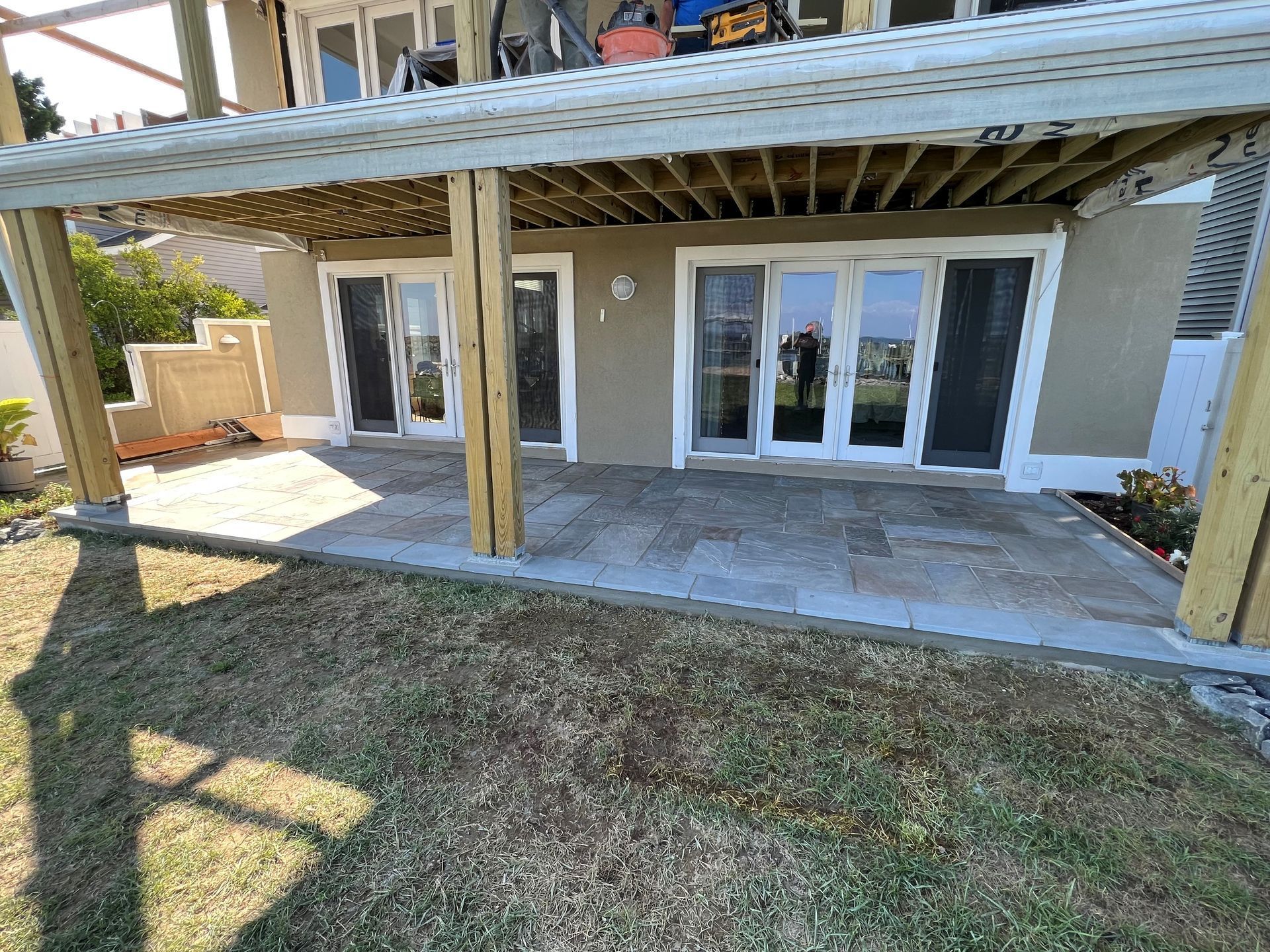 a house under construction with a patio and sliding glass doors .