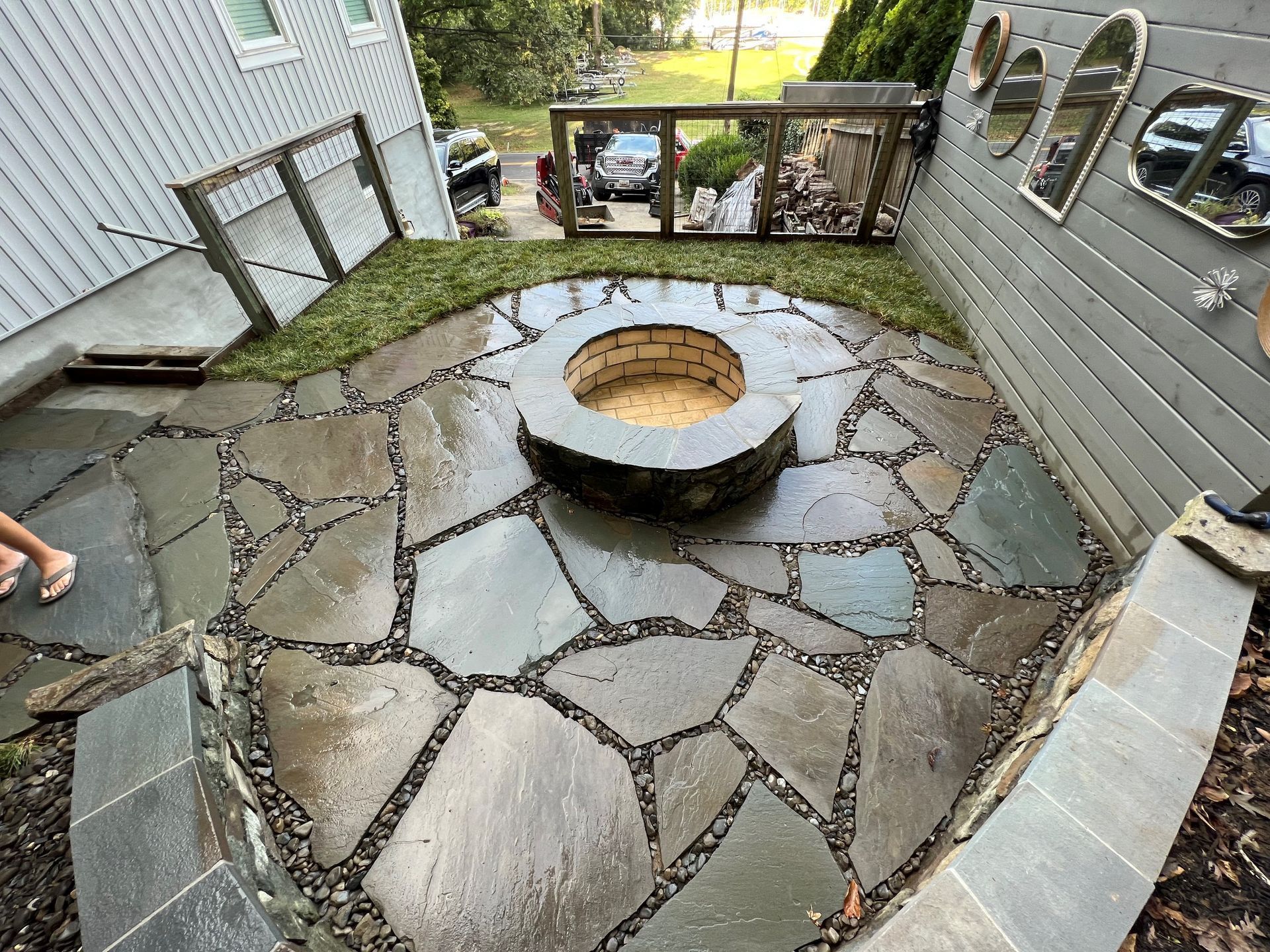 there is a fire pit in the middle of the patio .