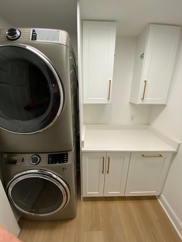 A washer and dryer are stacked on top of each other in a laundry room.