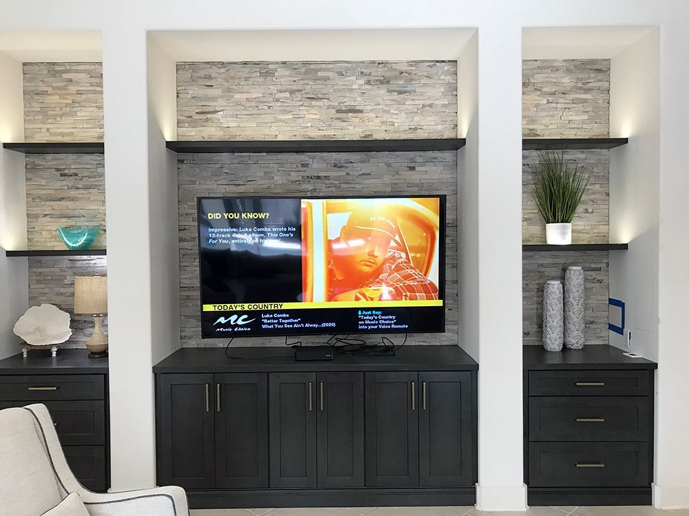 A living room with a flat screen tv and a chair