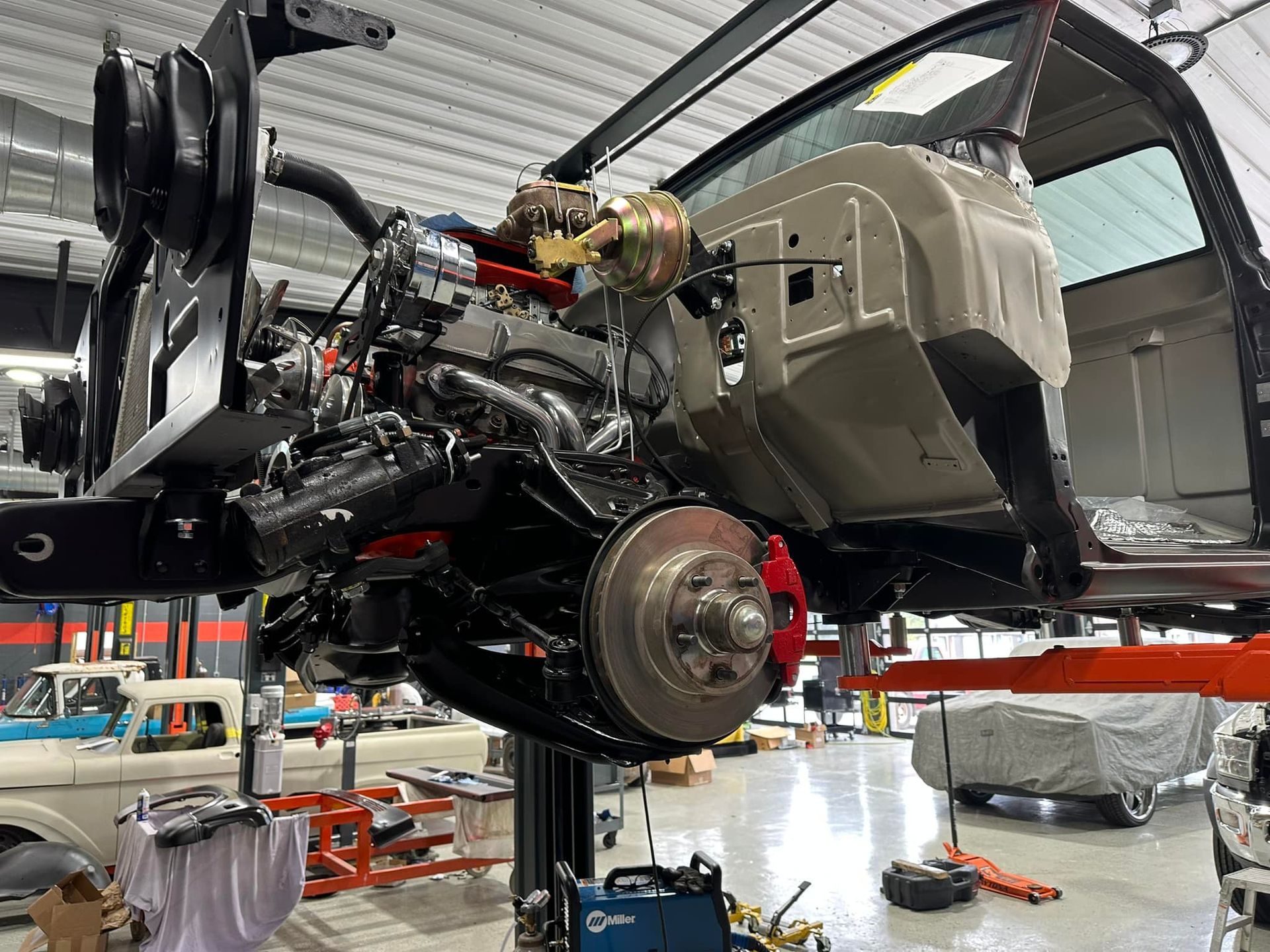 A car engine is being worked on in a garage.