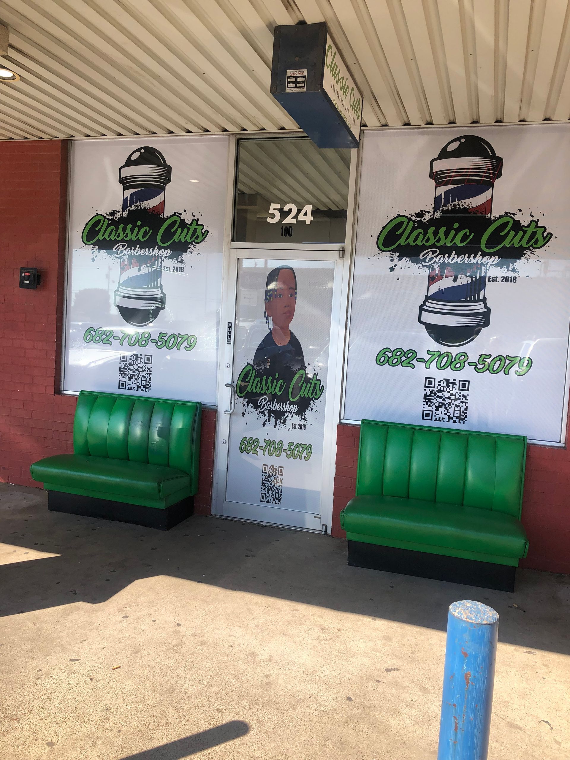 Storefront with green benches and window decals reading “Classic Cuts,” door number 524.