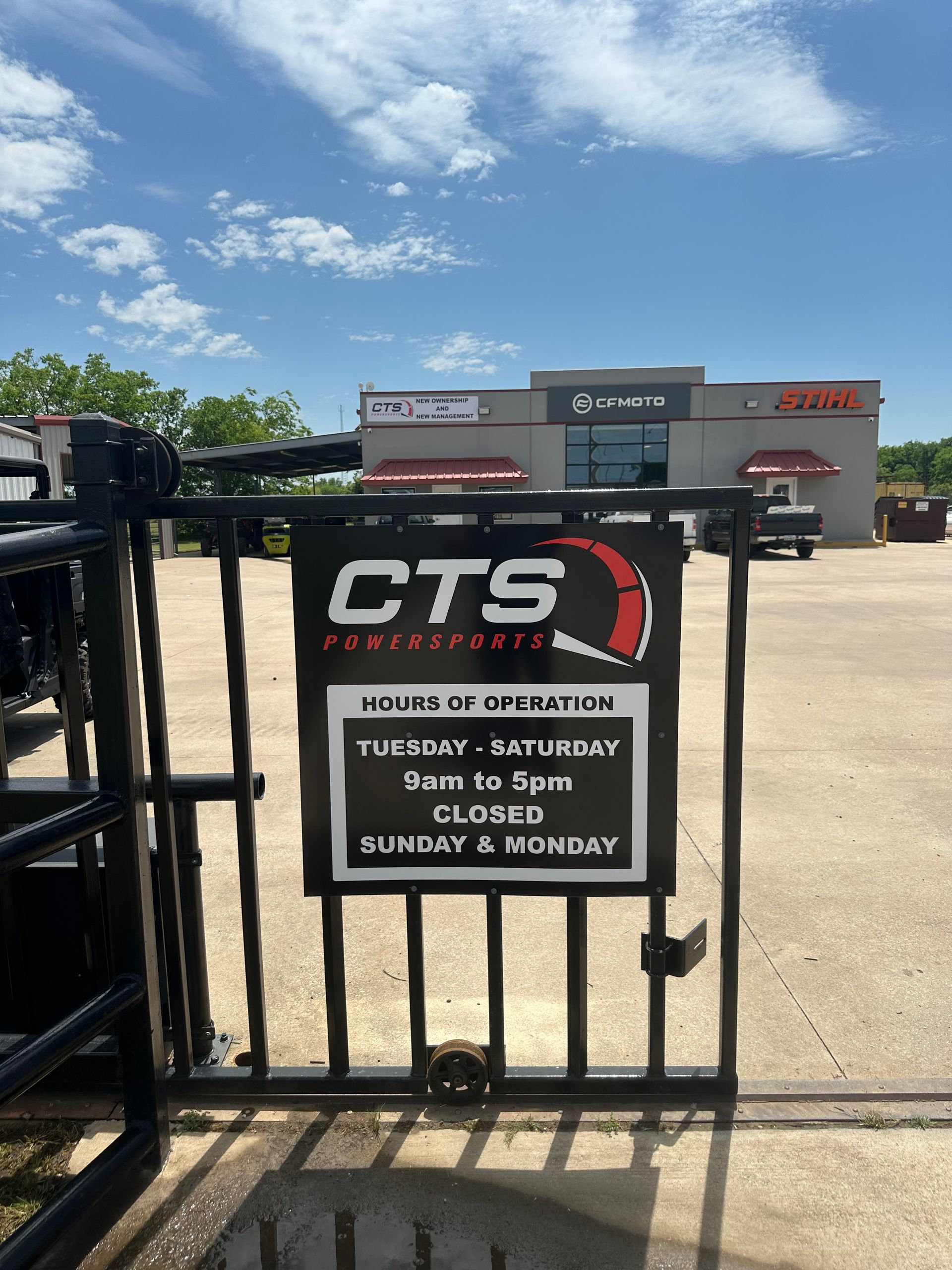 Closed CTS gate with warning sign outside a shopping center on a sunny day