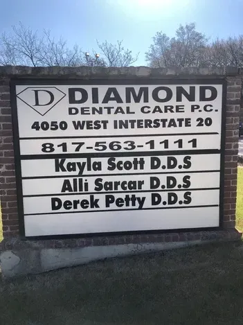 Diamond Dental Care sign with phone number and dentists’ names outside the office