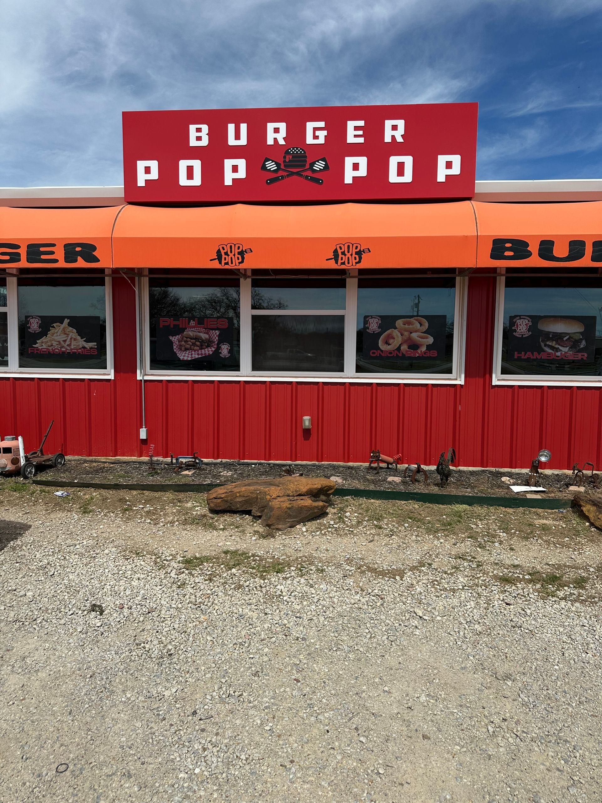 Red Burger Pop Pop roadside restaurant with red facade and gravel lot