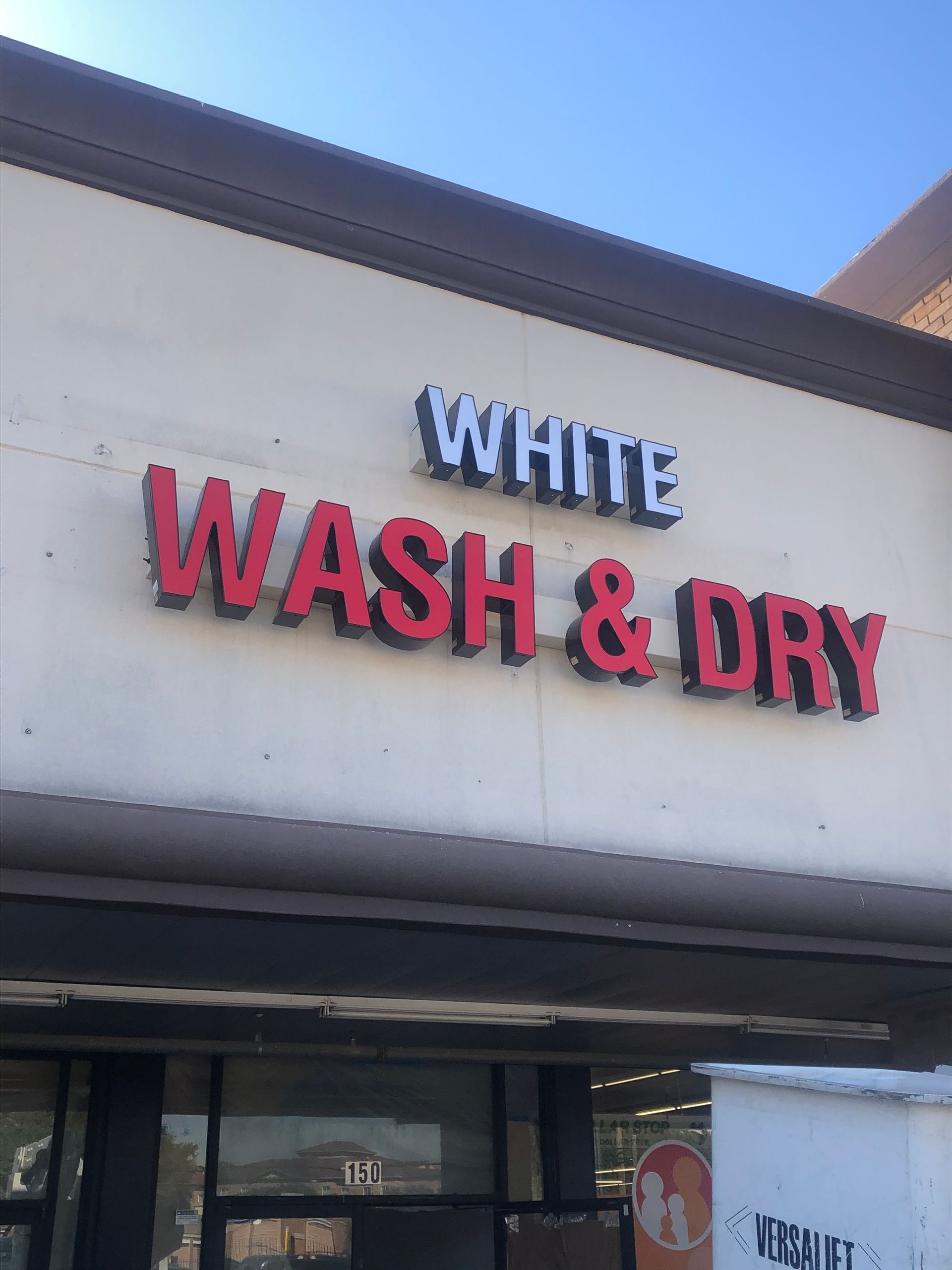 White Wash & Dry laundromat sign on a building exterior