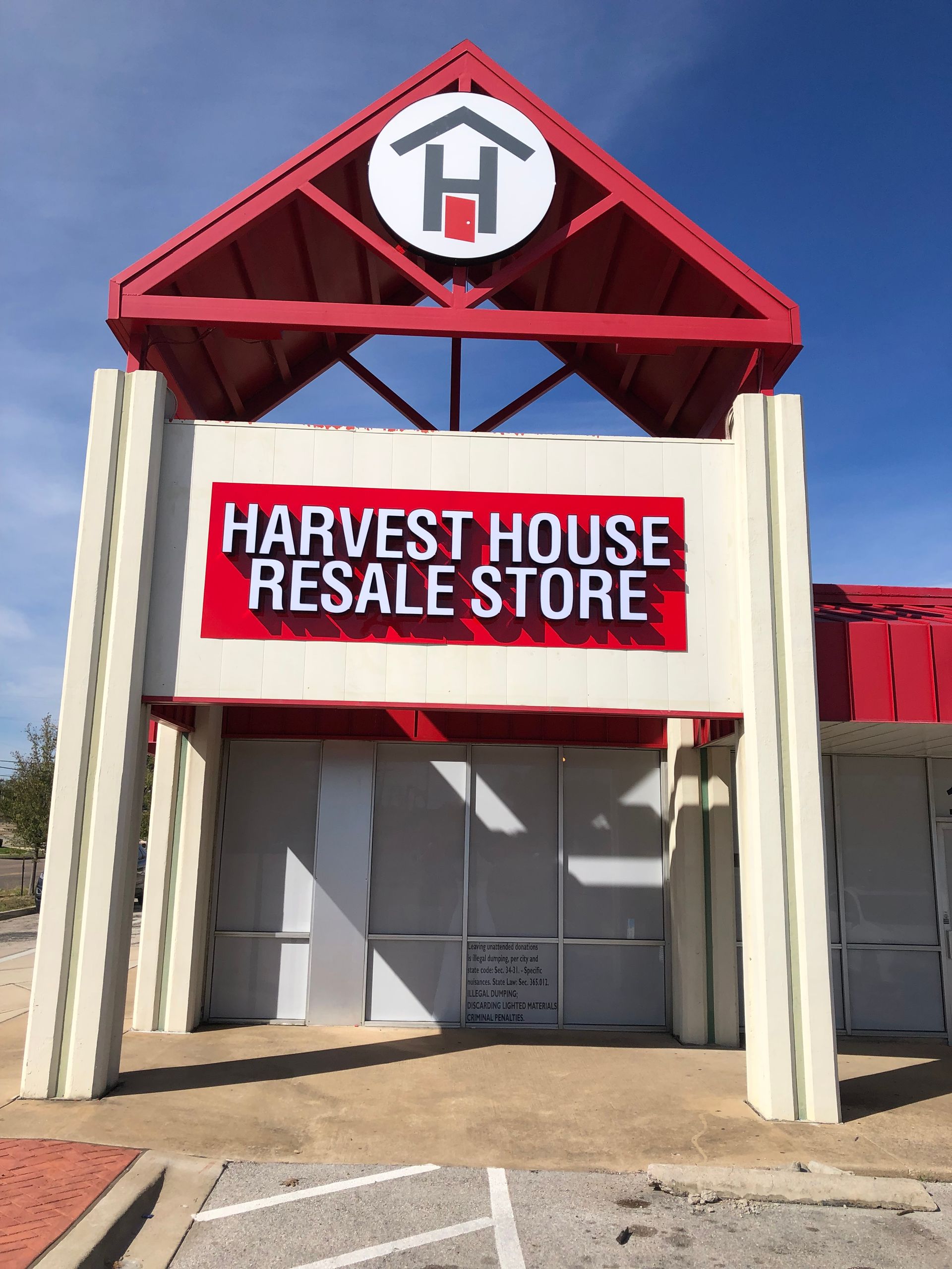 Harvest House Resale Store storefront with red-and-white sign and entrance canopy