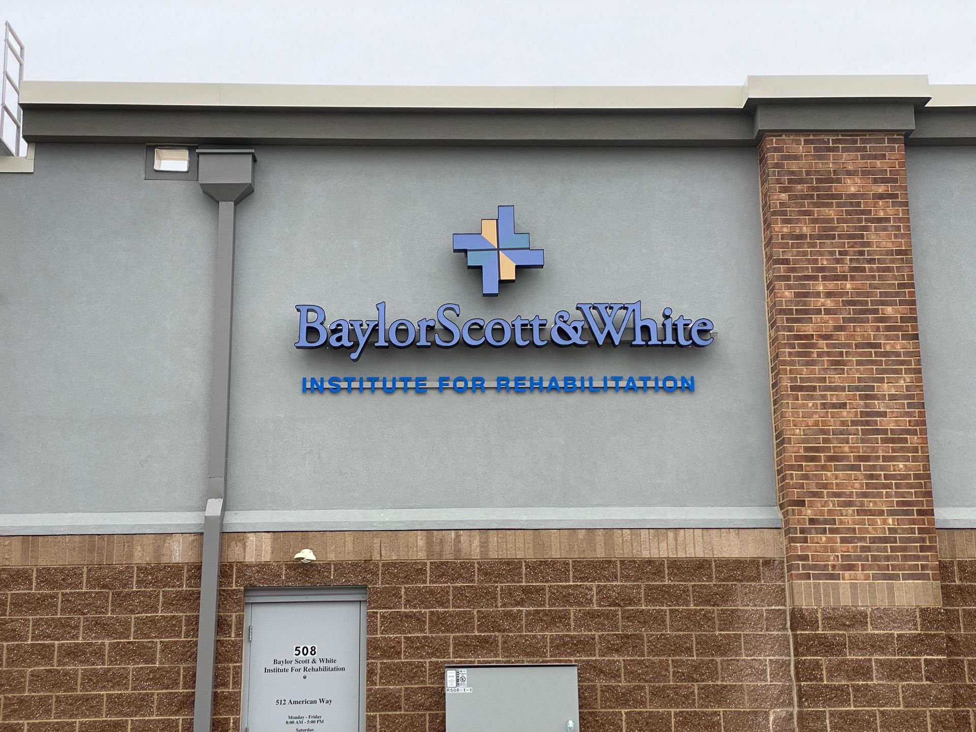 Baylor Scott & White Institute for Rehabilitation sign on a gray brick building