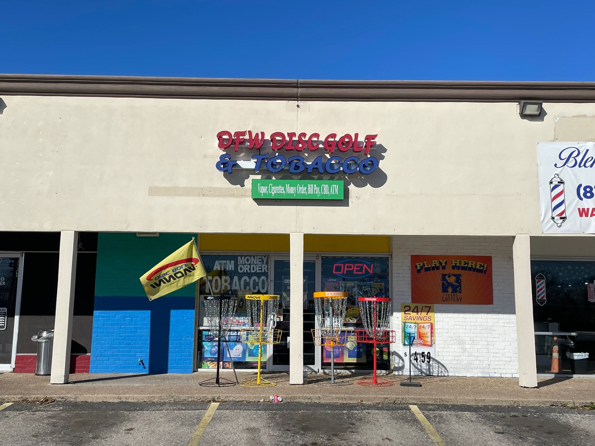Storefront with blue doors and signage, featuring the words “Deli,” “Grocery,” and “Liquor” above the entrance.