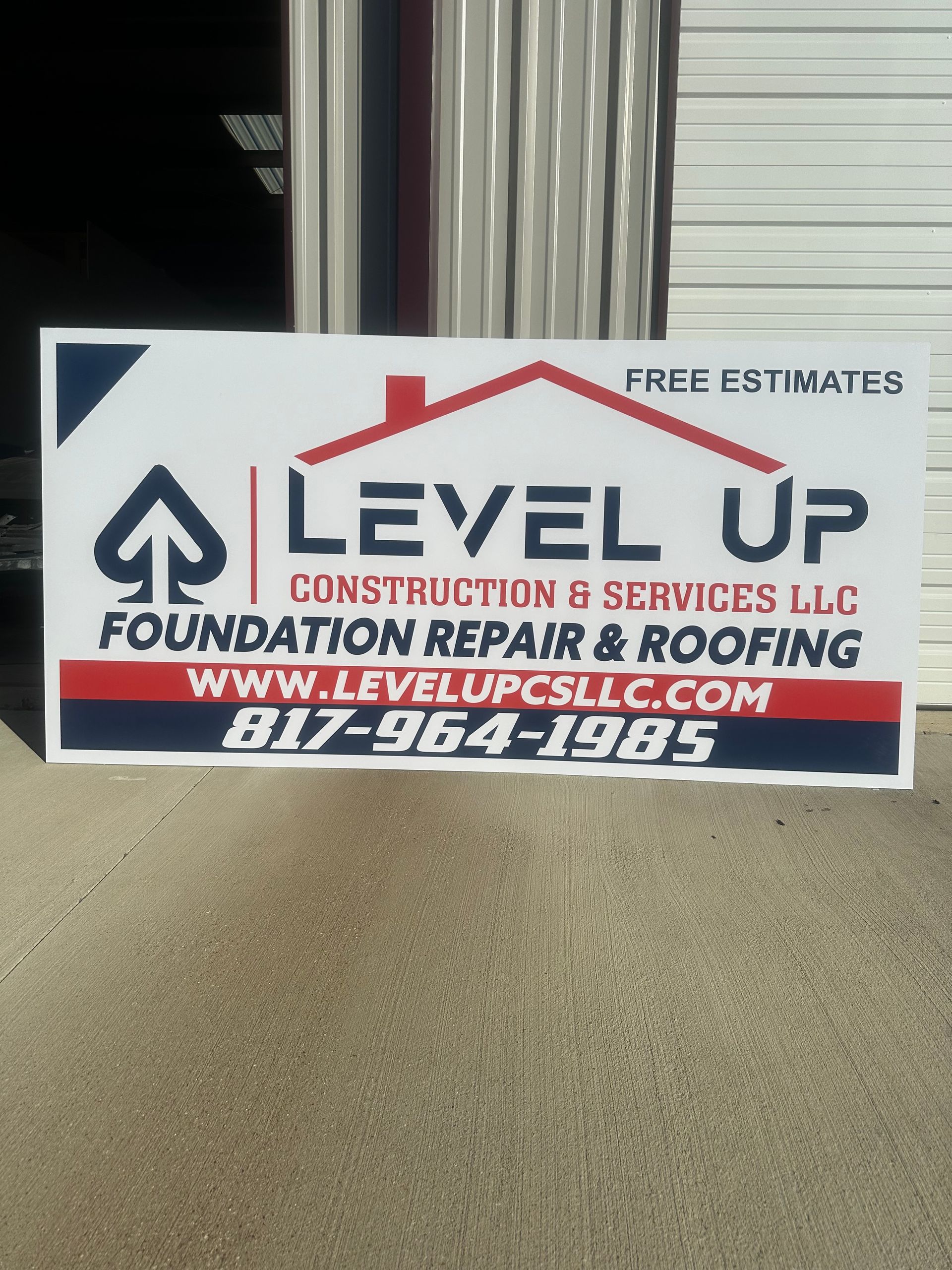 Level Up Construction & Services LLC sign with website, phone number, and free estimates, on a carpeted floor.