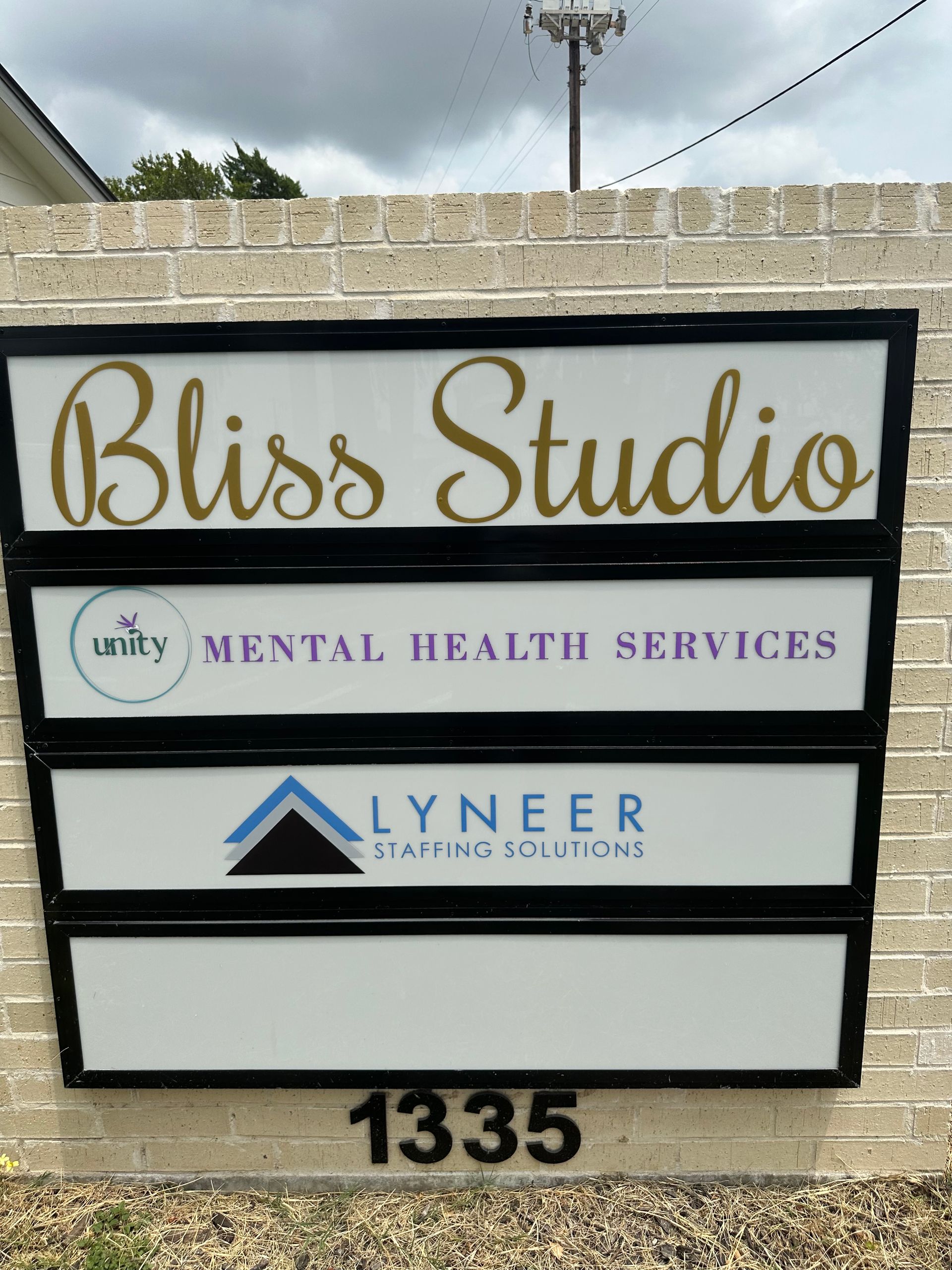 Bliss Studio sign for mental health services and Lyneer Staffing Solutions, with address 1335.