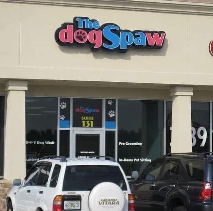 Dog spa storefront with parked cars and a sign reading “The dog Spaw.”