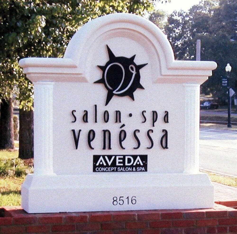 White stone sign for Salon Spa Vanessa with Aveda logo and address 8516.