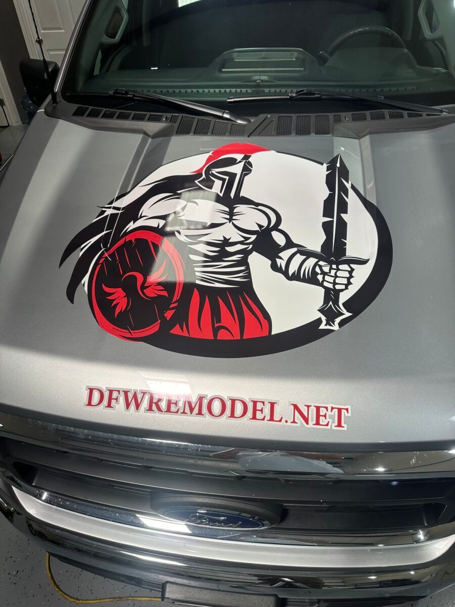 Truck hood with a red-and-black medieval warrior logo and DFWK9MODEL.NET text.