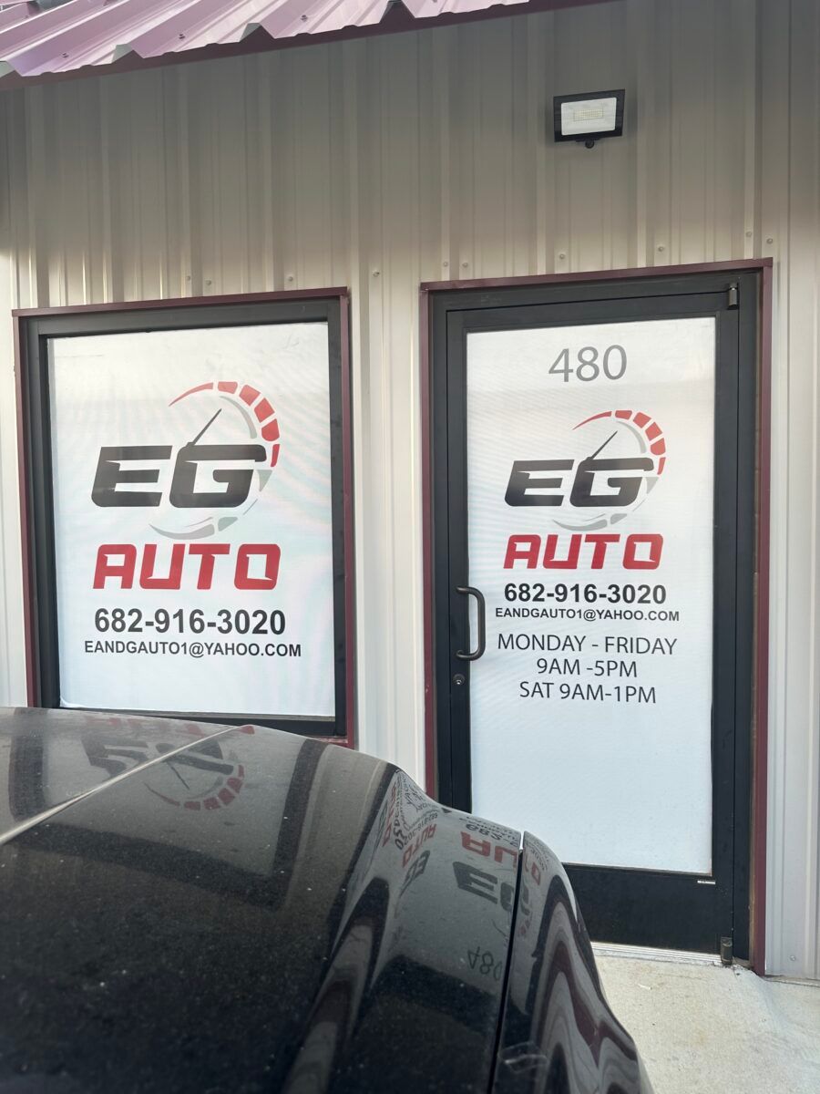 EG Auto storefront with two doors, sign, address 480, and a black car in front
