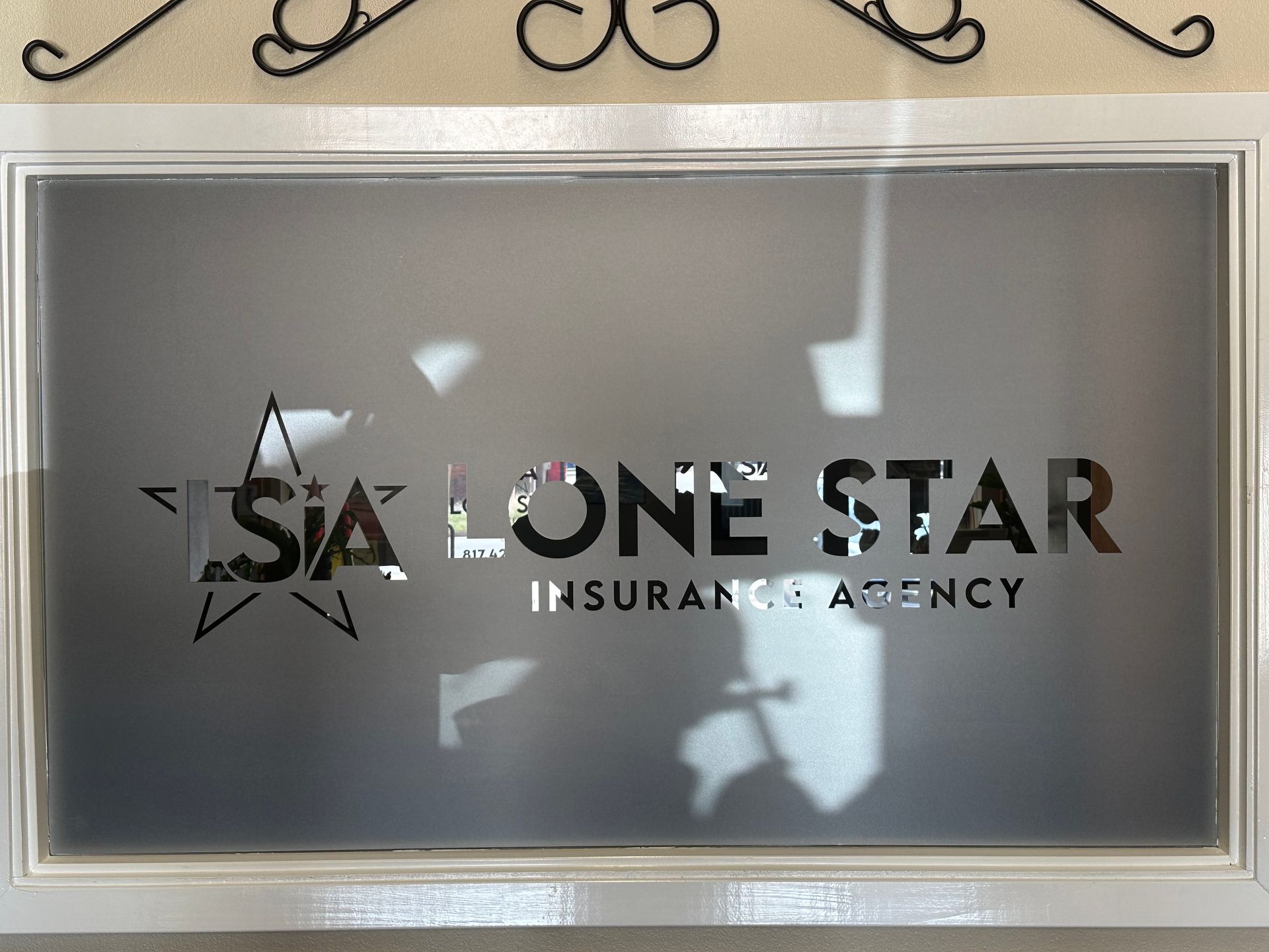 One Star Insurance Agency logo on a framed gray sign with reflections