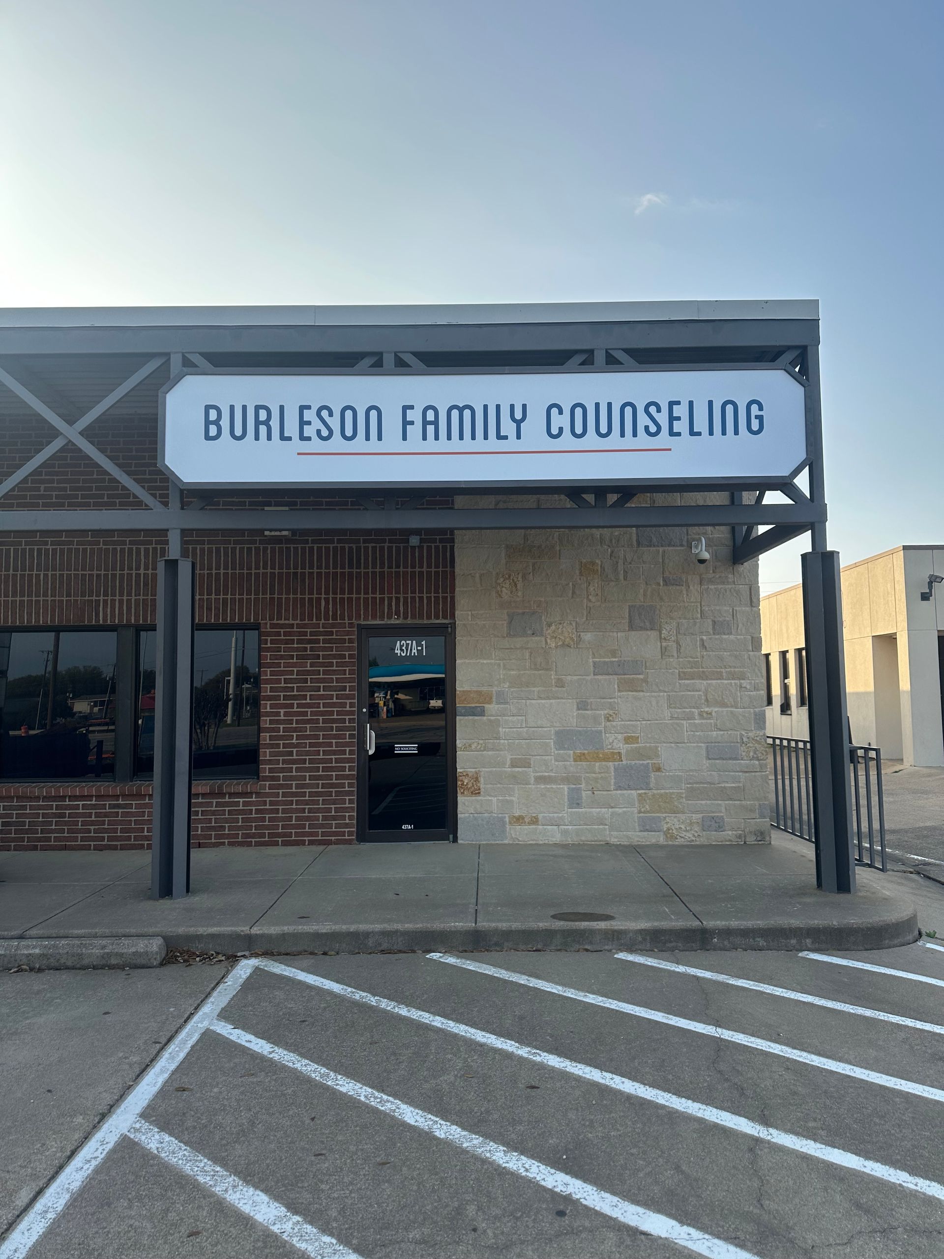 Burleson Family Counseling storefront with stone facade and striped accessible parking space