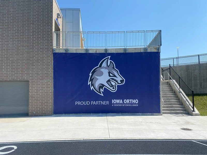 A blue banner featuring a wolf mascot logo and the text 