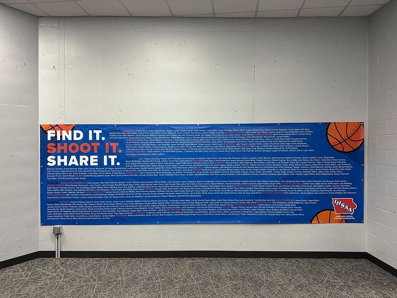 A blue banner on a white wall reads 