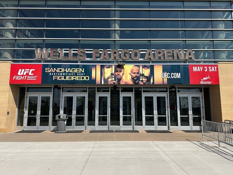 Wells Fargo Arena entrance with a large banner advertising a UFC Fight Night event featuring Sandhagen vs. Figueiredo.