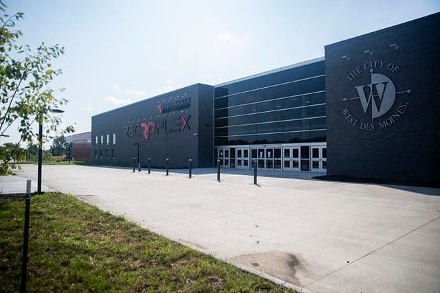 The MidAmerican Energy Company RecPlex building in West Des Moines, featuring dark gray walls and a glass-paneled entrance.