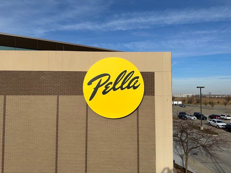 A yellow circular sign with the black script logo 