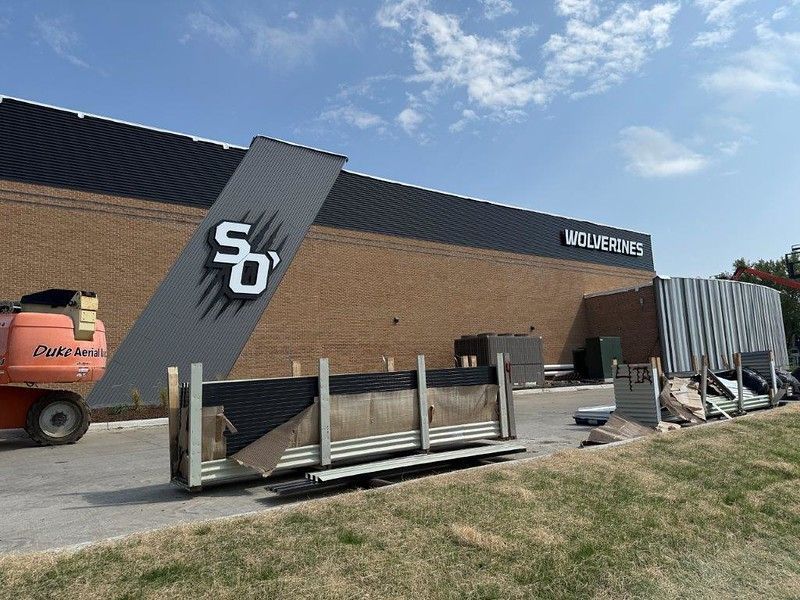 A brick building under construction with a large 