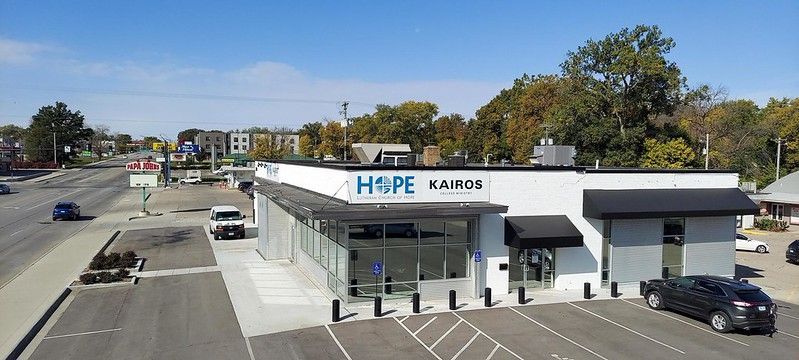 An aerial view of a white, modern one-story building labeled 