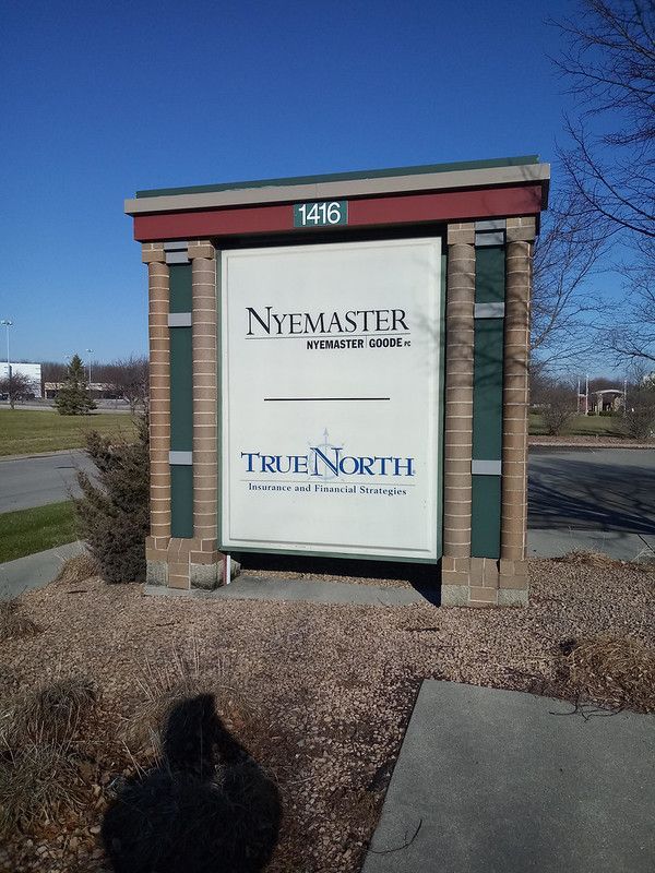 A monument sign for Nyemaster Goode and True North at 1416, set in an outdoor area on a sunny day.