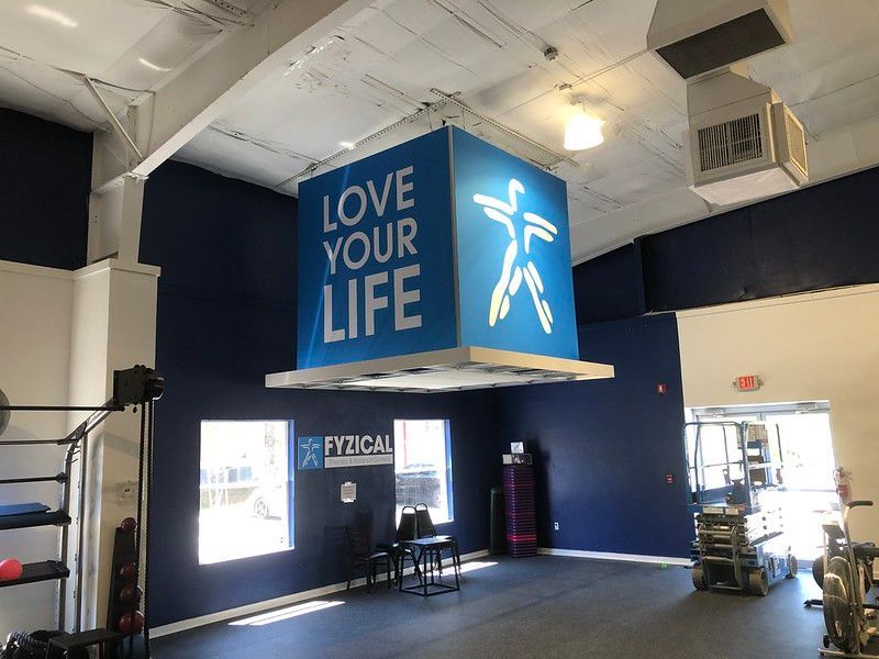 A blue hanging sign reading 