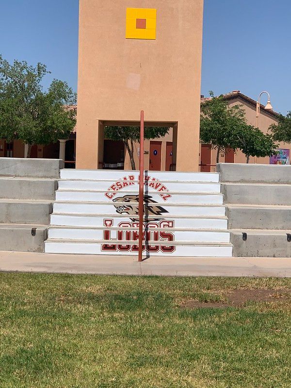 A staircase at Cesar Chavez school featuring the school mascot, the Lobos, painted in red and white on the risers.