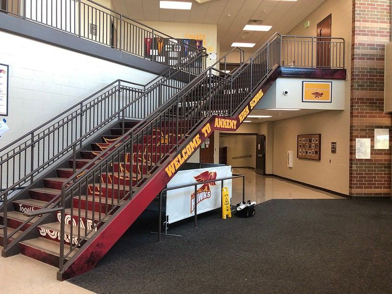 Staircase inside Ankeny High School with a banner reading 