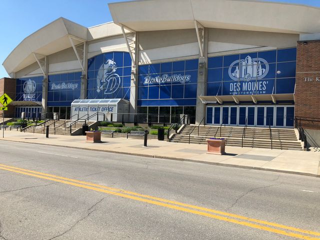 Exterior of Lee Miles building with blue mural panels and steps along the sidewalk.