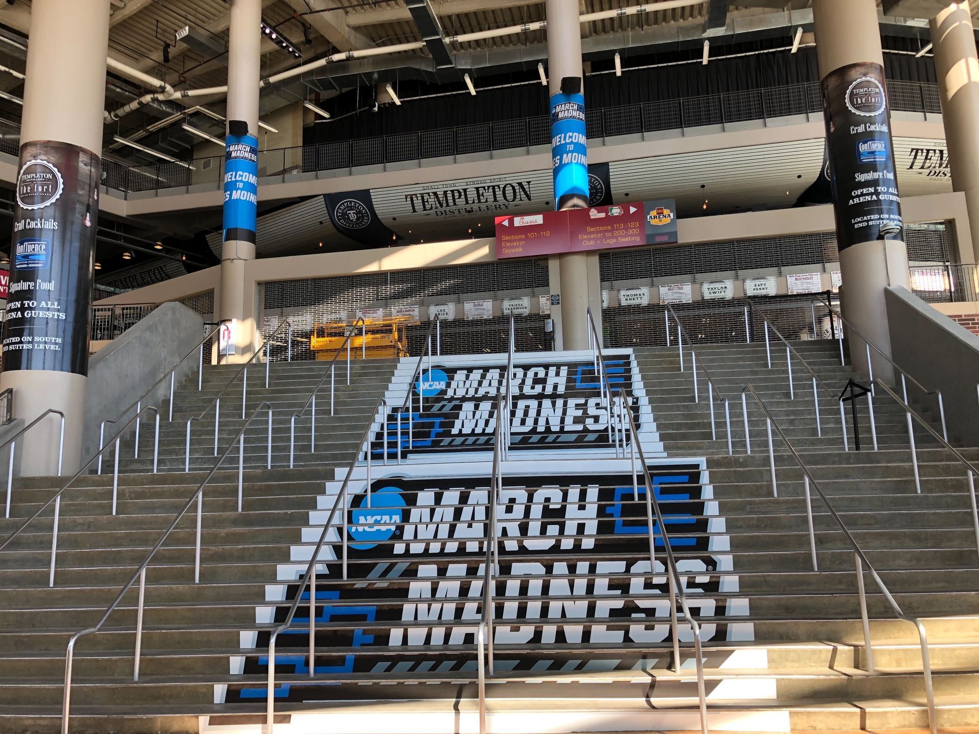 Stadium staircase with March Madness branding and blue-and-black banners.