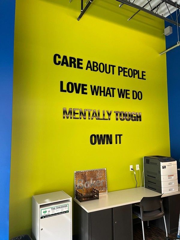 A lime green wall featuring the black text: 